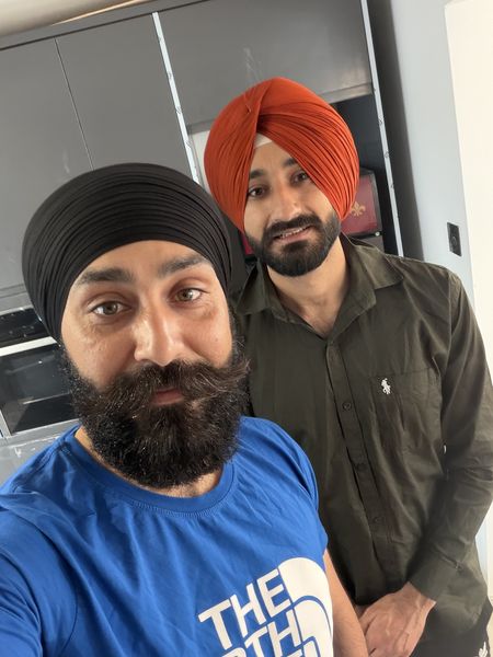 Black and orange dastar tied by Thind Turban Tying Centre