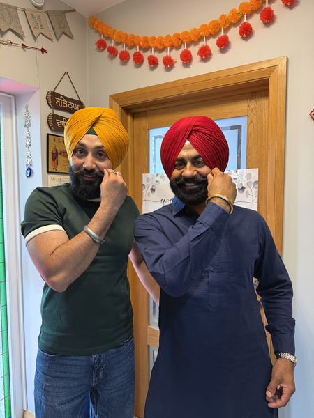 Wedding guests in mustard and red turbans tied in Middlesbrough