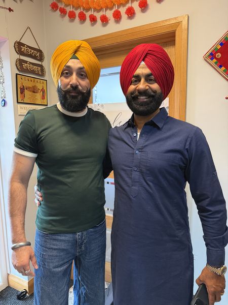 Two guests with freshly tied turbans at a Teesside Sikh wedding