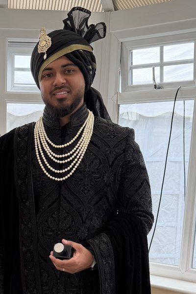 Muslim groom in a black and gold saafa tied by Thind Turban Tying Centre