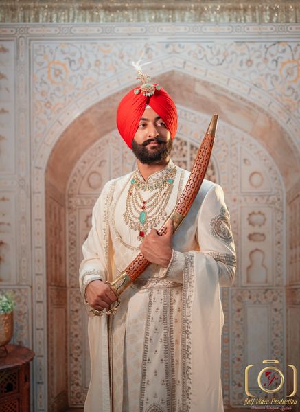 Sikh groom's dastar finished with a kalgi for his wedding day